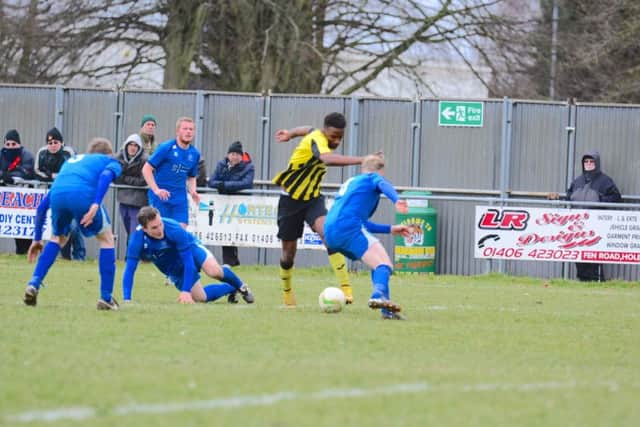 Holbeach United striker Sean Coughlan tries to dribble through the Cogenhoe defence. Photo: Steve Relf.