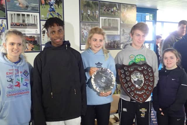 Harriers cross-country runners who did well at RAF Cranwell. From the left are Imogen Woodard, Denzel Mposu, Olivia Ozkan (holding Under 15 girls trophy), Ollie Bowling (holding Under 17 mens trophy) and Beth Goymour.