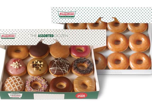 Krispy Kreme's double dozen doughnuts in the firm's iconic green dotty box.