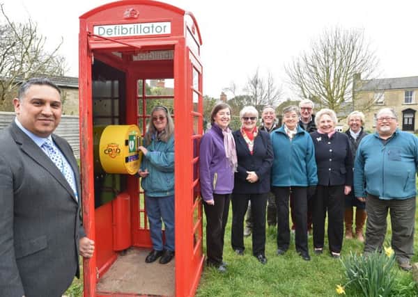 Shabbir Damani (local pharmacist)  with locals at the opening of the defibrillator unit in telephone box at Ailsworth EMN-160323-181112009