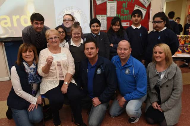Andy and Stuart Simmonds with mum Chris Simmonds and Holli Posnett with staff and pupils at Heltwate at presentation of the cheque from the Dragon and Ploughman pubs in Werrington.