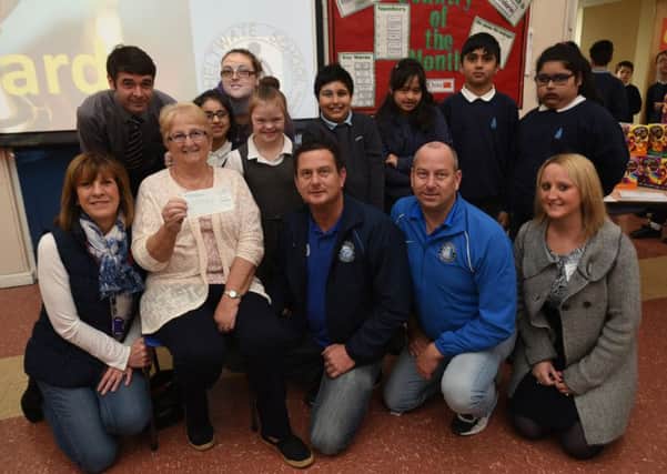 Andy and Stuart Simmonds with mum Chris Simmonds and Holli Posnett with staff and pupils at Heltwate at presentation of the cheque  from the Dragon and Ploughman pubs in Werrington.