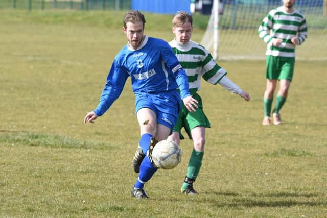 Action fron Bretton North End Reserves (blue) v George, Oundle. Photo: David Lowndes.