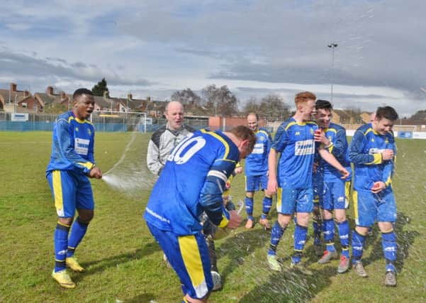 The champagne flows as Peterborough Sports celebrate their United Counties Division One title win. Photo: David Lowndes.
