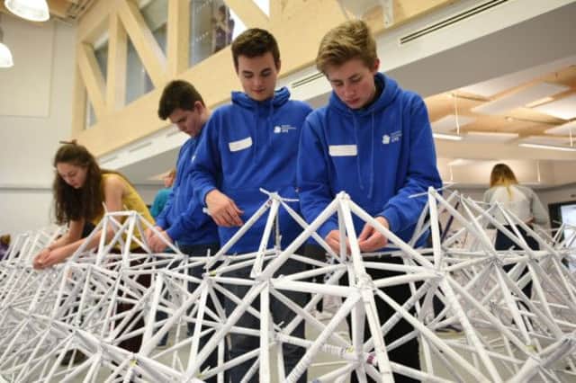 Students finishing off the world record breaking paper structure