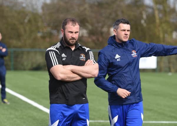 New Yaxley manager Andy Furnell (left) watches his side against Deeping Rangers. Photo: David Lowndes.