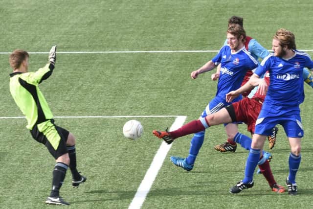 Action from Yaxley's (blue) 2-2 draw with Deeping Rangers. Photo: David Lowndes.