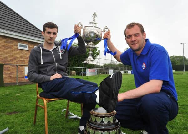 Brett Whaley (right) with the Hinchingbrooke Cup he won in a previous spell with Yaxley.