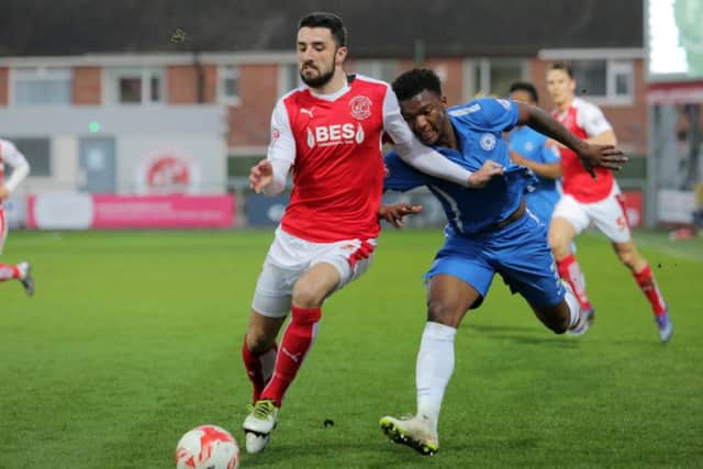 Fleetwood full-back Conor McLaughlin fends of Posh full-back Kgosi Ntlhe. Photo: Joe Dent/theposh.com.
