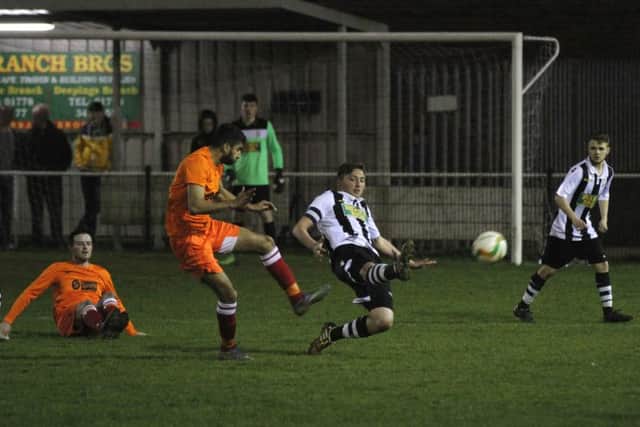 Peterborough Northern Star goalscorer Calum Madigan (stripes) in action against Kirby Muxloe. Photo: Tim Gates.