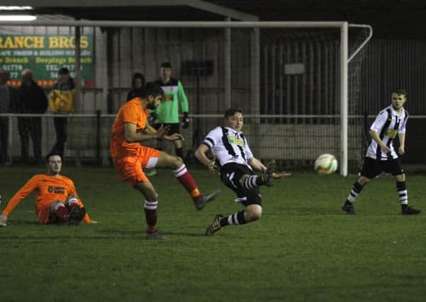 Peterborough Northern Star goalscorer Calum Madigan (stripes) in action against Kirby Muxloe. Photo: Tim Gates.