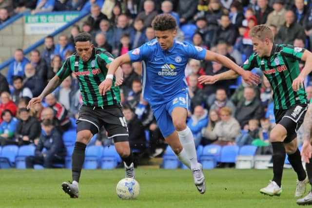 Lee Angol of Peterborough United battles with Nathaniel Mendez-Laing of Rochdale. Picture: Joe Dent