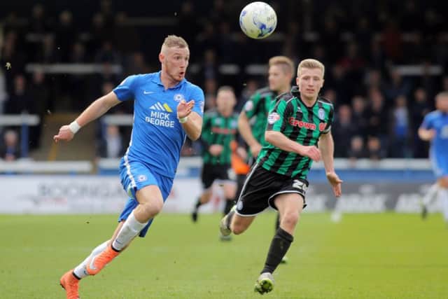 Marcus Maddison of Peterborough United in action with Jamie Allen of Rochdale. Picture: Joe Dent