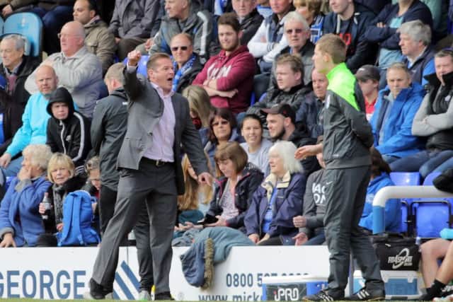 Peterborough United manager Graham Westley questions a decision with the fourth official during last Saturday's defeat by Rochdale. Picture: Joe Dent