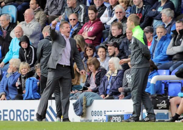 Peterborough United manager Graham Westley questions a decision with the fourth official during last Saturday's defeat by Rochdale. Picture: Joe Dent