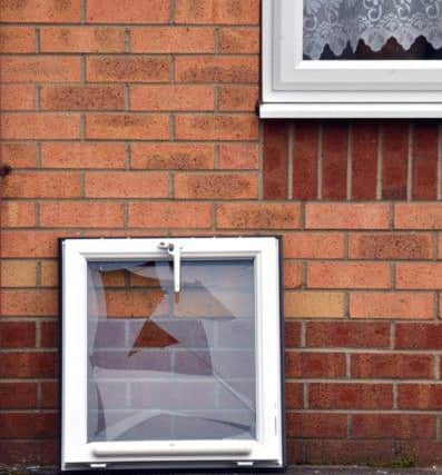 A broken window at the front of the house.