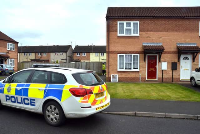 A police car outside the home where the bodies were found.
