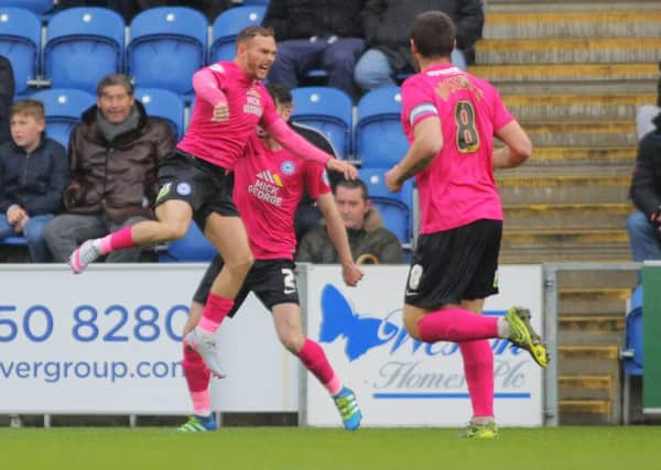 Jon Taylor of Peterborough United (left) jumps for joy after scoring the opening goal of the game. Picture: Joe Dent