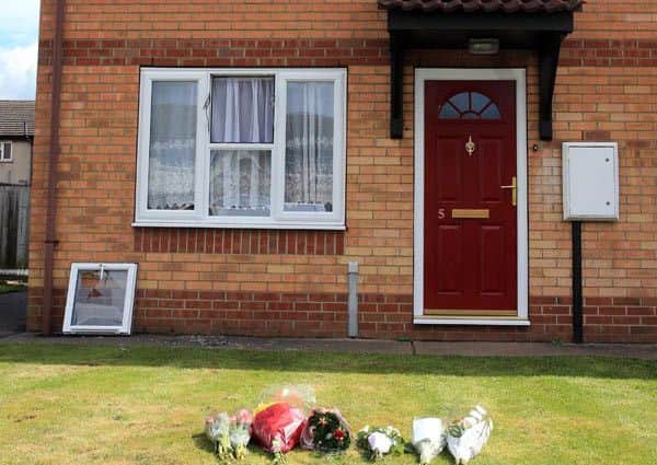 Flowers outside of the home where the bodies of a Spalding mum and her teenage daugher were found. ANL-160416-185123001