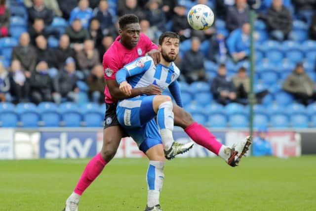 Posh defender Ricardo Santos gets to grips with Elliott Lee of Colchester. Photo: Joe Dent/JMP.
