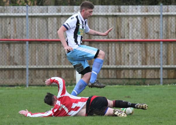 Callum Madigan of Peterborough Northern Star hurdles a challenge in the game at AFC Kempston Rovers. Photo: Tim Gates.