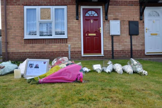 Flowers outside the house where Elizabeth Edwards and her 13-year-old daughter Katie were murdered. ANL-160417-120047001