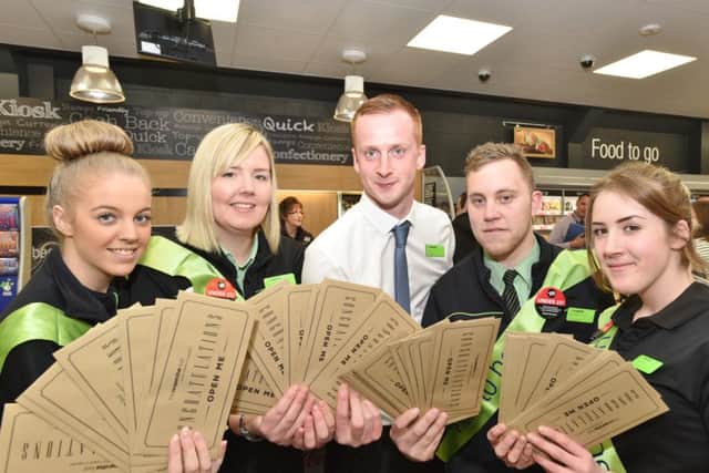Co-operative store manager Lee Whittaker and staff hand out golden tickets.