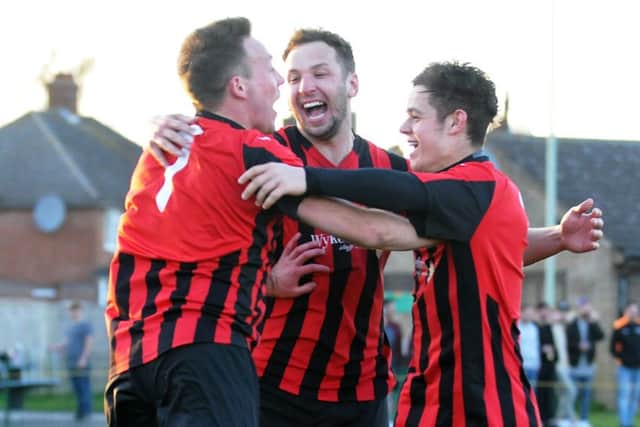 Pinchbeck players celebrate their win over Moulton Harrox. Photo: Tim Wilson.