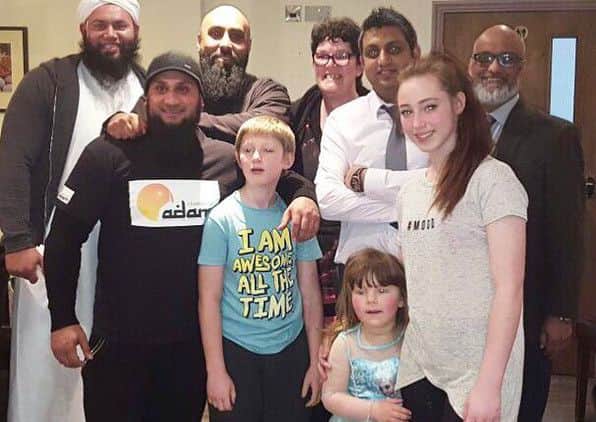 Mandi and her family with the team from Children of Adam