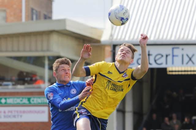 Posh's Harry Beautyman tries to win a header against Conor Townsend of Scunthorpe. Photo: Joe Dent/theposh.com.