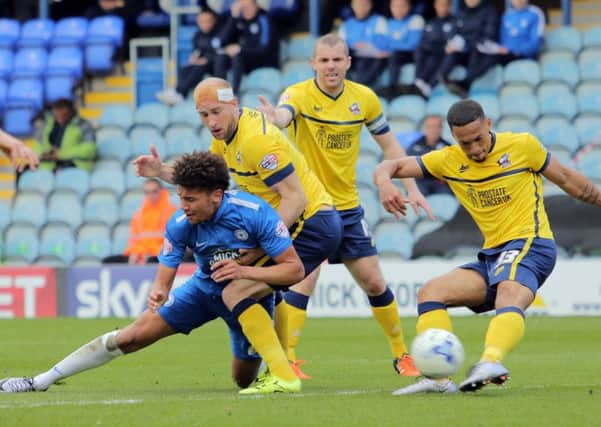 Posh striker Lee Angol tries to win possession on the edge of the Scunthorpe penalty area. Photo: Joe Dent/theposh.com.
