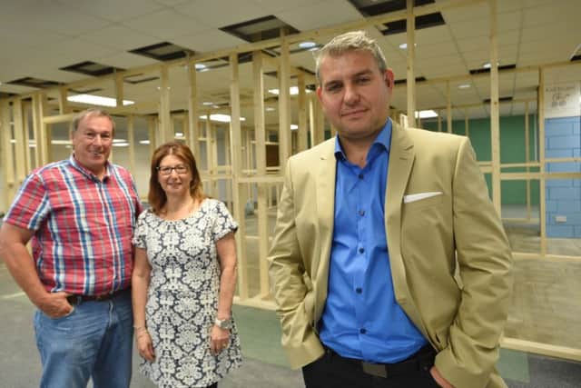 Paul Wright and Val Kaye with chief executive Jamie Martin, front.  EMN-150714-192315009