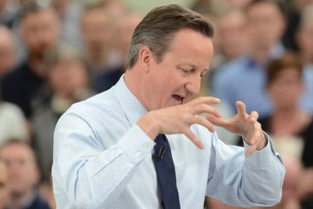 Prime Minister David Cameron makes a point during his visit to Perkins Engines.