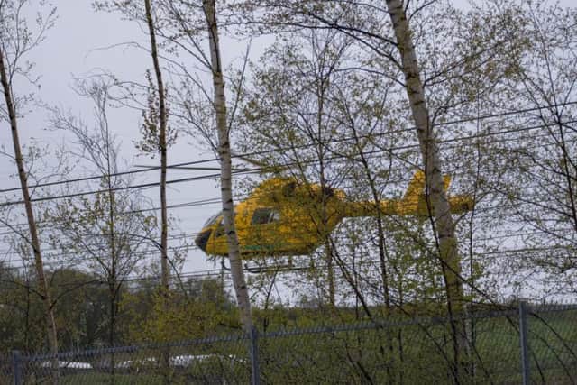 The air ambulance lands at the scene. Photo credit: Darren Brown