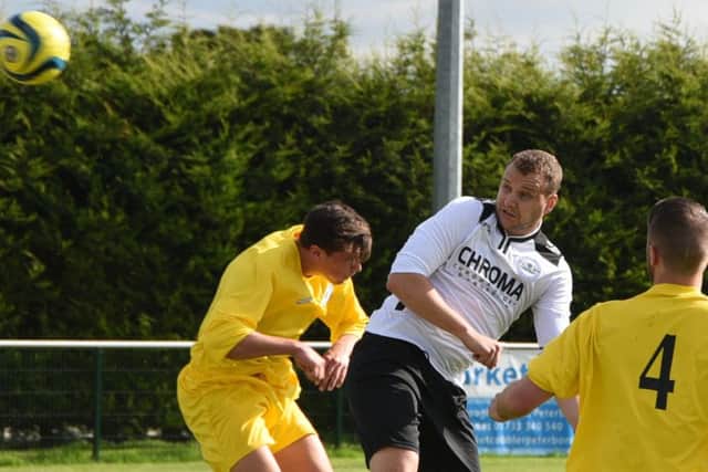 Matt Heron (white) scored for Whittlesey Athletic at Moulton Harrox.