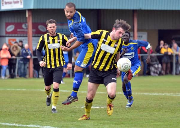 Peterborough Sports' penalty hero Ollie Medwynter (blue) in action in the United Counties League Cup Final. Photo: Tim Wilson.