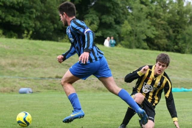 Jake Pell (blue) played strongly for Whittlesey against Netherton.