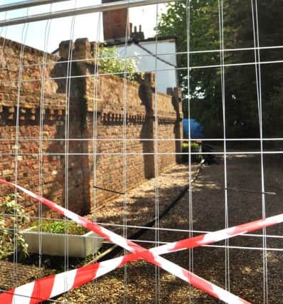 A barricade blocks the lane to the fire-wrecked house. SG030516-107TW