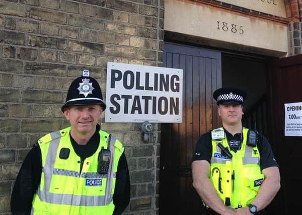 Police at a polling station in Peterborough