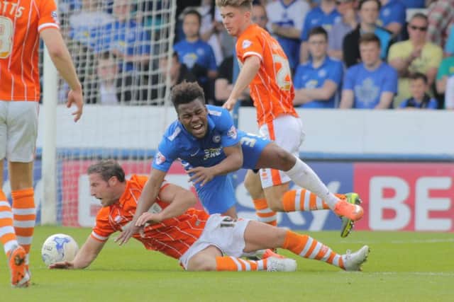 It's a penalty for Posh as Shaquile Coulthirst is fouled by Blackpool's David Norris. Photo: Joe Dent/theposh.com.