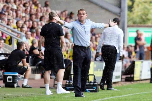 Posh boss Dave Robertson questions a refereeing decision at Burton in August. Photo: Joe Dent/theposh.com.