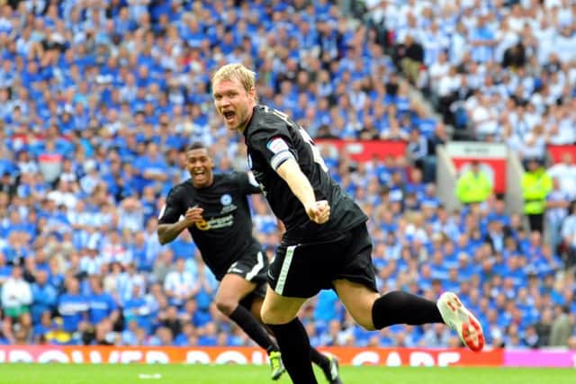 Grant McCann celebrates his Posh goal in the League One play-off final ain against Huddersfield at Old Trafford.