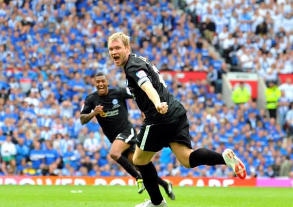 Grant McCann celebrates his Posh goal in the League One play-off final ain against Huddersfield at Old Trafford.