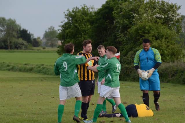 A flashpoint in the play-off match between Eye United (green) and Bretton North End. Photo: David Lowndes.