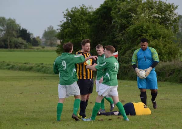 A flashpoint in the play-off match between Eye United (green) and Bretton North End. Photo: David Lowndes.