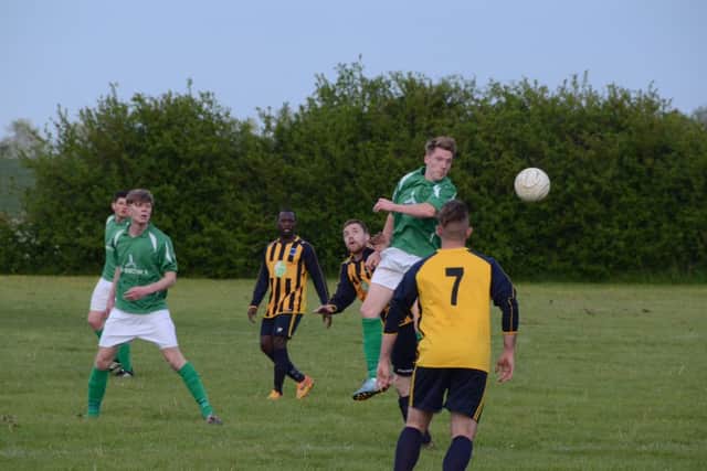 Action from the play-off match between Eye United (green) and Bretton North End. Photo: David Lowndes.