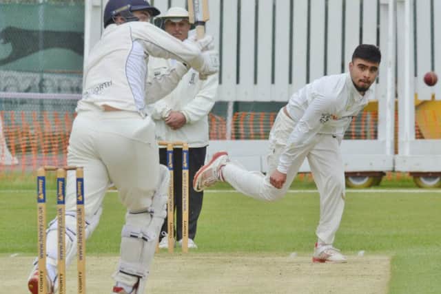 Peterborough Town's Mohammed Danyaal bowling against Brixworth.
