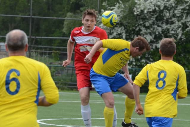 Action from the Peterborough League Division Two play-off final between Polonia (red) and Spalding Town. Photo: David Lowndes.