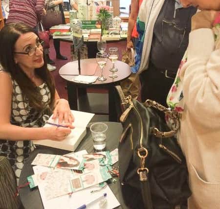 Eva Jordan signing copies of her book