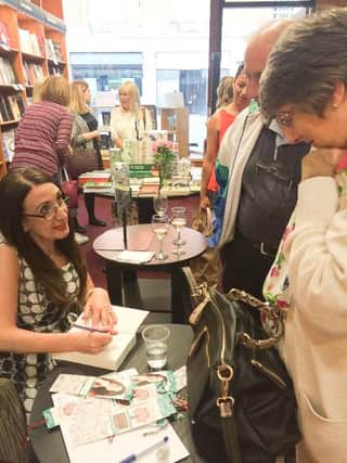 Eva Jordan signing copies of her book